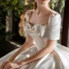 Timeless Satin Ball Gown Wedding Dress with Short Sleeves & Bow Accent