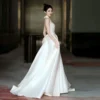 Sleek Halter Neck Satin Wedding Dress with Open Back & Pockets