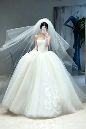 Whimsical Strapless Tulle Ball Gown Wedding Dress with Subtle Floral Embroidery