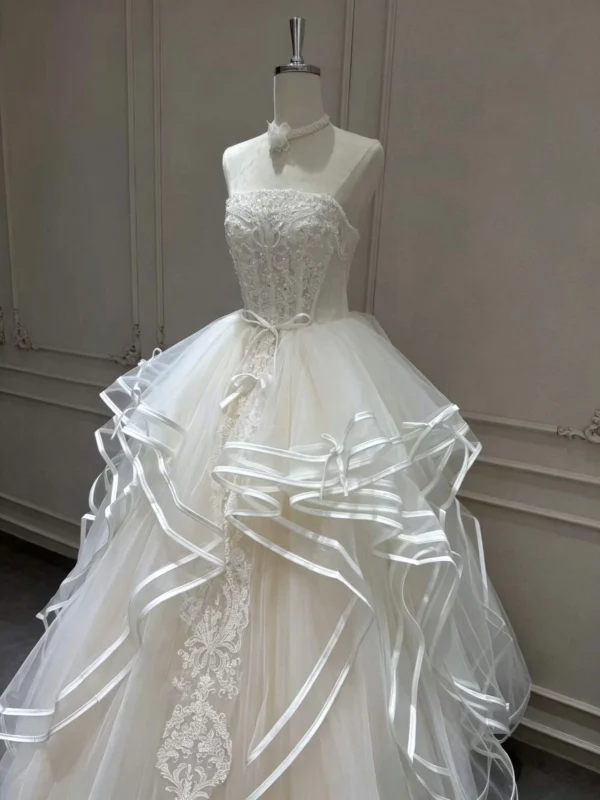 Tiered Wave Bridal Gown with Delicate Bow Ribbon and Vertical Lace Applique