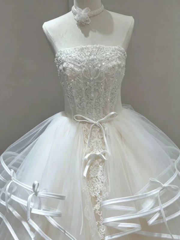 Tiered Wave Bridal Gown with Delicate Bow Ribbon and Vertical Lace Applique