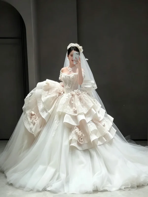 Whimsical Tiered Tulle Bridal Gown with Floral Accents